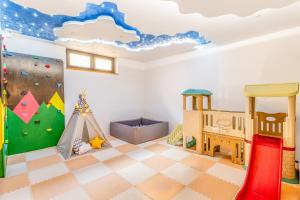 a room with a playroom with a ceiling with a mural at Rezydencja Zakopane in Zakopane