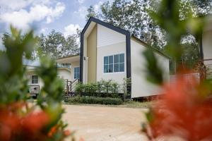a house with a black and white facade at NaraRin Phuket Resorts in Thalang