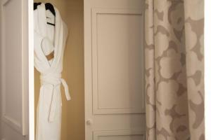 a closet with white towels and a door at Hôtel Le Relais Saint Charles in Paris