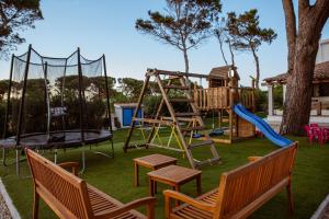 a playground with a slide and a swing set at Villa Rose Sardegna in Calasetta