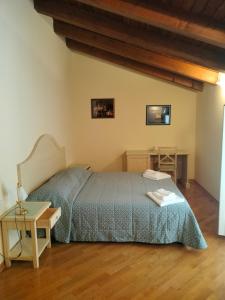 a bedroom with a bed and a table at Agriturismo Hermada in Duino