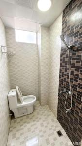 a bathroom with a toilet and a shower at YangShuo Backpacker Hostel West Street Branch in Yangshuo +19 photos