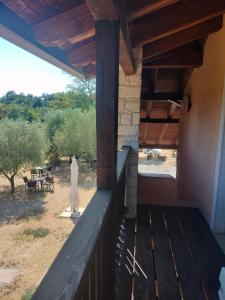 a man standing on the porch of a house at Agriturismo Hermada in Duino