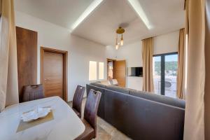 a living room with a table and a couch at ZIS LUX Sea View in Kravlja