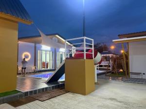 a house with a slide next to a pool at My friend private pool villa in Samut Songkhram