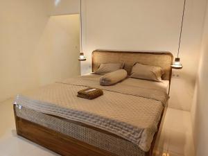 a bedroom with a bed with a large mirror on it at AWAN Homestay in Kuta Lombok