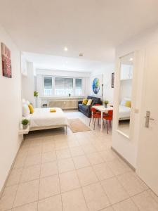 a bedroom with a bed and a living room at Private Urban Studio 18 - Luxembourg Central in Luxembourg
