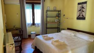 a bedroom with a bed with two towels on it at B&B Muggianeddu in Tonara
