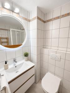 a bathroom with a sink and a toilet and a mirror at Private Urban Studio 18 - Luxembourg Central in Luxembourg