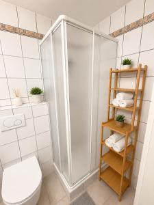 a bathroom with a shower with a toilet and towels at Private Urban Studio 18 - Luxembourg Central in Luxembourg