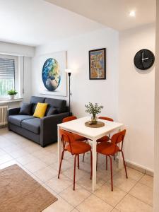 a living room with a table and chairs and a couch at Private Urban Studio 18 - Luxembourg Central in Luxembourg