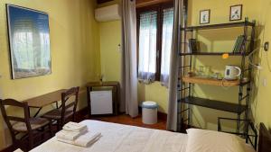 a room with a bed and a table and a table at B&B Muggianeddu in Tonara +2 photos