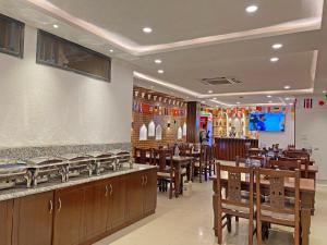 a restaurant with wooden tables and chairs and a bar at Shine Boutique Hotel in Kathmandu