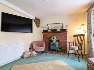 a living room with a fireplace and a flat screen tv at Pete's Place in Taunton