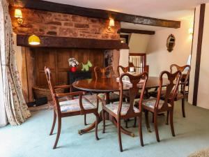 a dining room with a wooden table and chairs at Pete's Place in Taunton