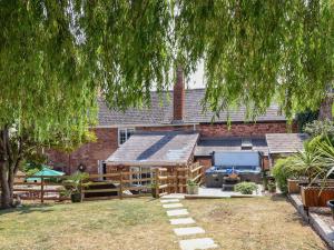a backyard with a log house with a grill at Pete's Place in Taunton