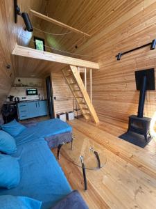 a room with a loft with a bed and a stove at Larda in Nankvam-Zagrali