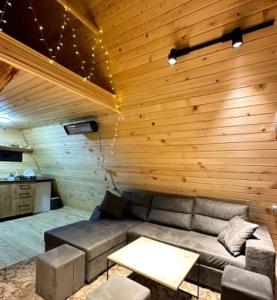 a living room with a couch and a table at Larda in Nankvam-Zagrali