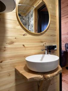 a bathroom with a white sink and a mirror at Larda in Nankvam-Zagrali +13 photos