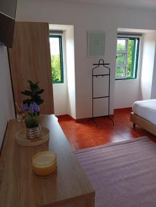 a living room with a bed and a table at Casa do Rio By Viva a Vida - Alojamentos & Hotels in Constância