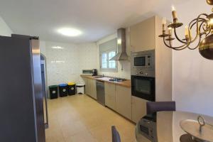 a kitchen with a table and a dining room at Opening Doors Premiá Dalt Amazing views w pool in Premia de Dalt