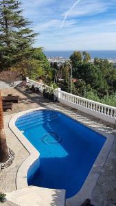 a large blue swimming pool on a patio at Opening Doors Premiá Dalt Amazing views w pool in Premia de Dalt