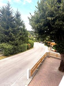 a fence on the side of a road with a tree at Apartments Chloe - Top 1 in Hollabrunn +4 photos