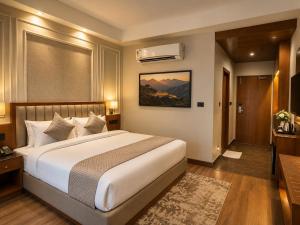 a bedroom with a large bed in a room at Tulip Tree Hotel in Katra +19 photos
