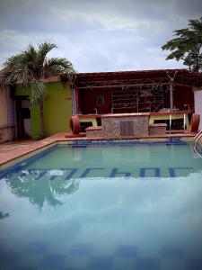 a large swimming pool in front of a building at October 1st Hotel in Ibadan