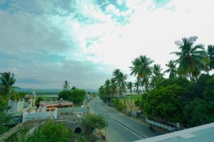 a street with palm trees on the side of a road at The Casa Comforts in New Hampi