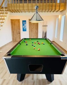 a pool table with balls on it in a room at Pensiunea Complex Castalia in Colina
