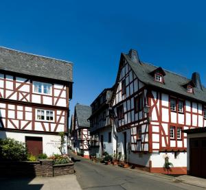 a group of half timbered buildings in a street at Gästehaus Schönblick in Sankt Aldegund