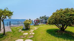 a garden with a view of the water at Sacheon Bichae Pension in Sacheon