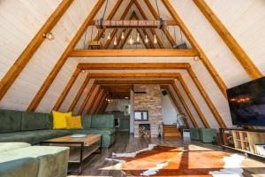 a living room with a green couch and a fireplace at KosMy dream in Sopot