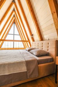 a bed in a loft with a large window at KosMy dream in Sopot +48 photos
