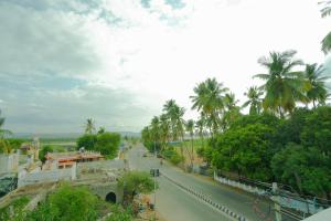 a street with palm trees on the side of a road at The Casa Comforts in New Hampi +53 photos