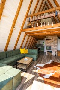 a living room with a green couch and a fireplace at KosMy dream in Sopot
