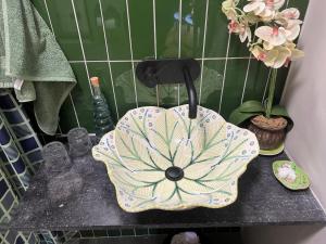 a bathroom counter with a flower shaped sink at Greyton Stay in Greyton +24 photos
