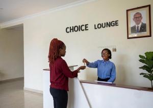 a woman standing next to a man in a lobby at Choice Lounge in Rubavu