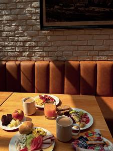 a table with two plates of breakfast foods on it at Kazalnica Family&Conference Resort by Solarento in Karpacz +68 photos