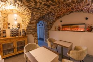 a room with a fireplace and a table and chairs at Adamello skyline in Temù