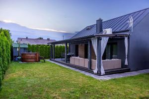 a house with a gazebo on the side of it at LR10 Dom Wakacyjny in Lubogoszcz