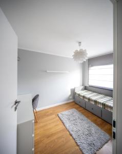 a white room with a bed and a white rug at LR10 Dom Wakacyjny in Lubogoszcz