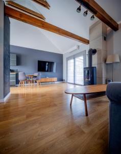 a living room with a table and a fireplace at LR10 Dom Wakacyjny in Lubogoszcz