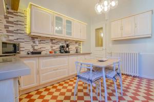 a kitchen with a table and two chairs in it at L'instant champenois - all inclusive in Bréviandes