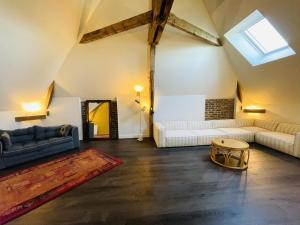 a living room with two couches and a table at L'instant champenois - all inclusive in Bréviandes