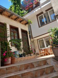 a building with potted plants on the steps at Vila Kosta City Center Port in Ohrid