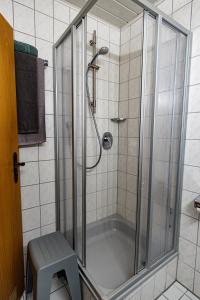a bathroom with a shower with a tub at Hotel Garni KAMBEITZ in Ötigheim +19 photos