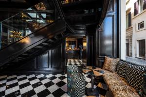 a living room with a couch and a checkered floor at Argentum Boutique Hotel & SPA in Rome