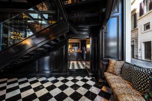 a living room with a staircase and a couch at Argentum Boutique Hotel & SPA in Rome